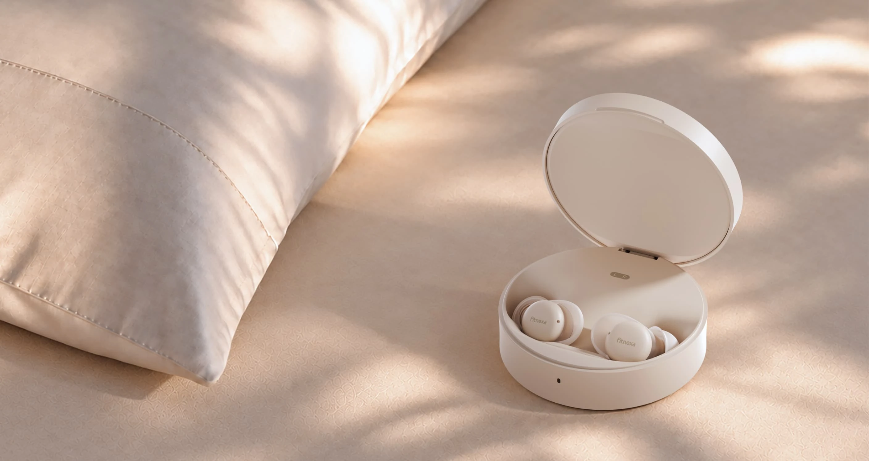 Fitnexa SomniPods 3 earbuds and charging case on bedding