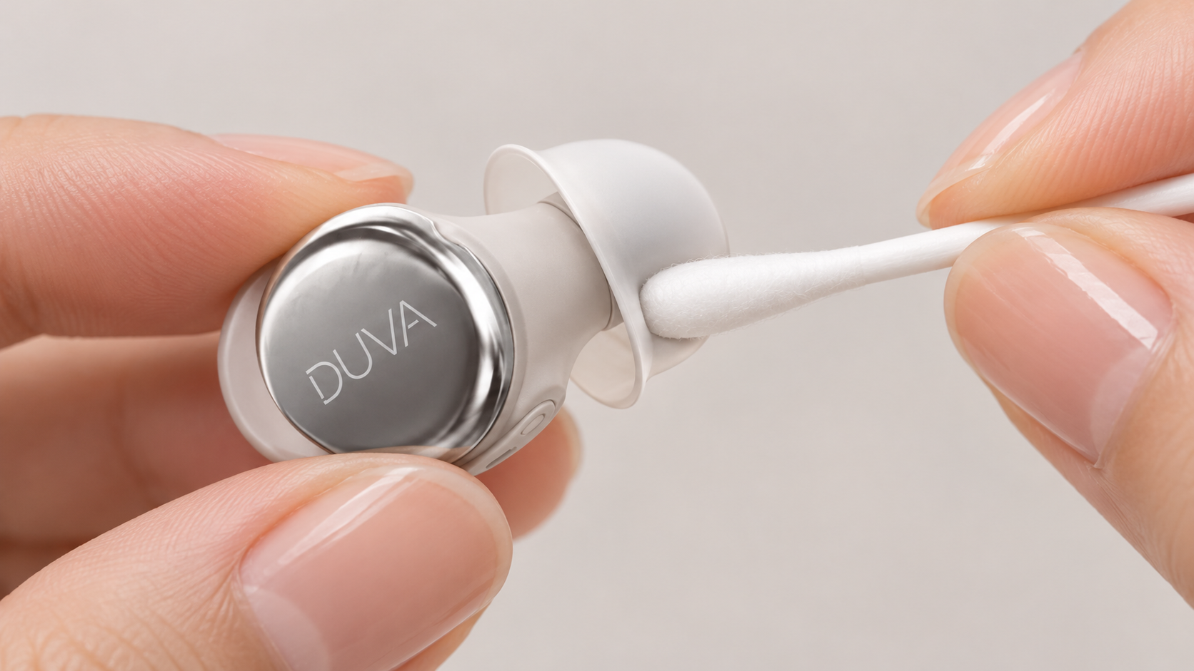 A DUVA earbud held next to a cotton swab near its silicone ear tip
